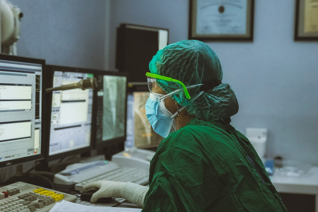 Doctor in PPE at workstation